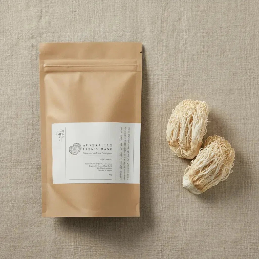 Lion's mane mushroom powder in a wooden bowl with dried lion's mane mushrooms, showcasing the benefits of functional mushroom supplementation